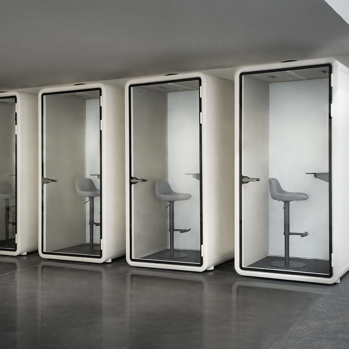 FocusPod booth positioned against a wall in an open-plan workspace